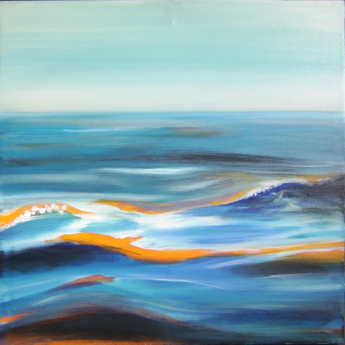 A curling wave in a pale blue seascape with warm orange reflections.
